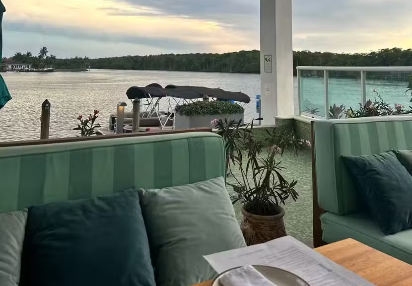 Boater docking at the private dock of Mykonos Kitchen & Bar for waterfront dining in Sunny Isles Beach